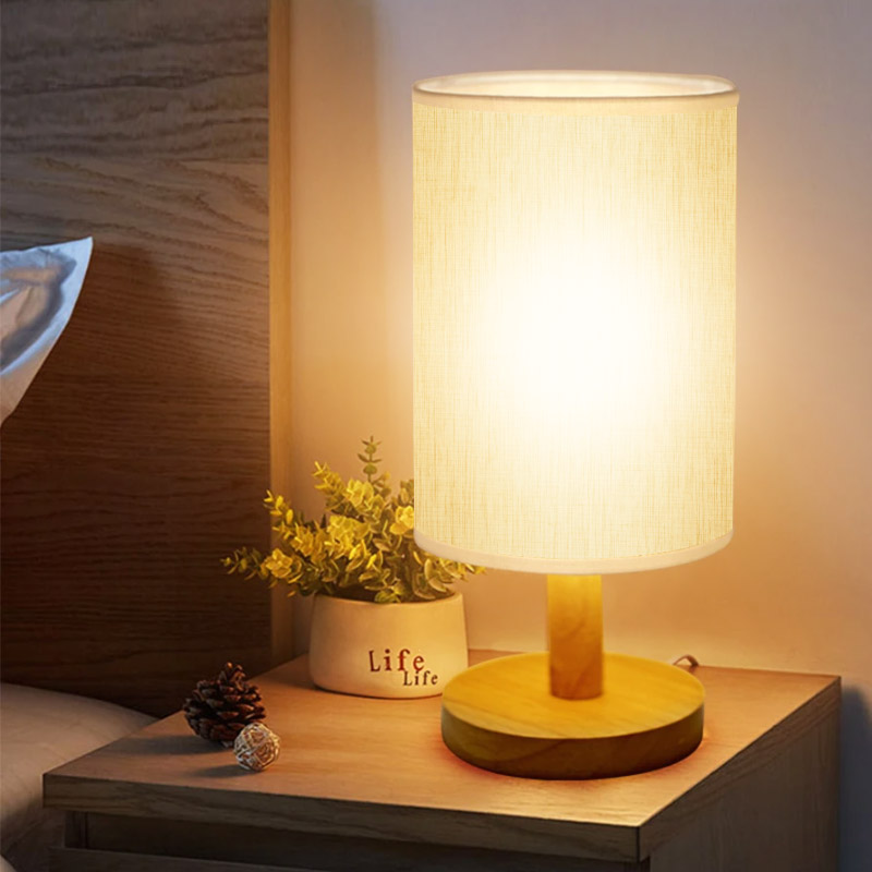 Product photo of KingDo wood-base bedside lamp with linen-look drum shade from its Lazada listing