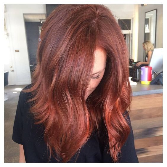 Blonde and red hair with curls and straight combined in one hairstyle