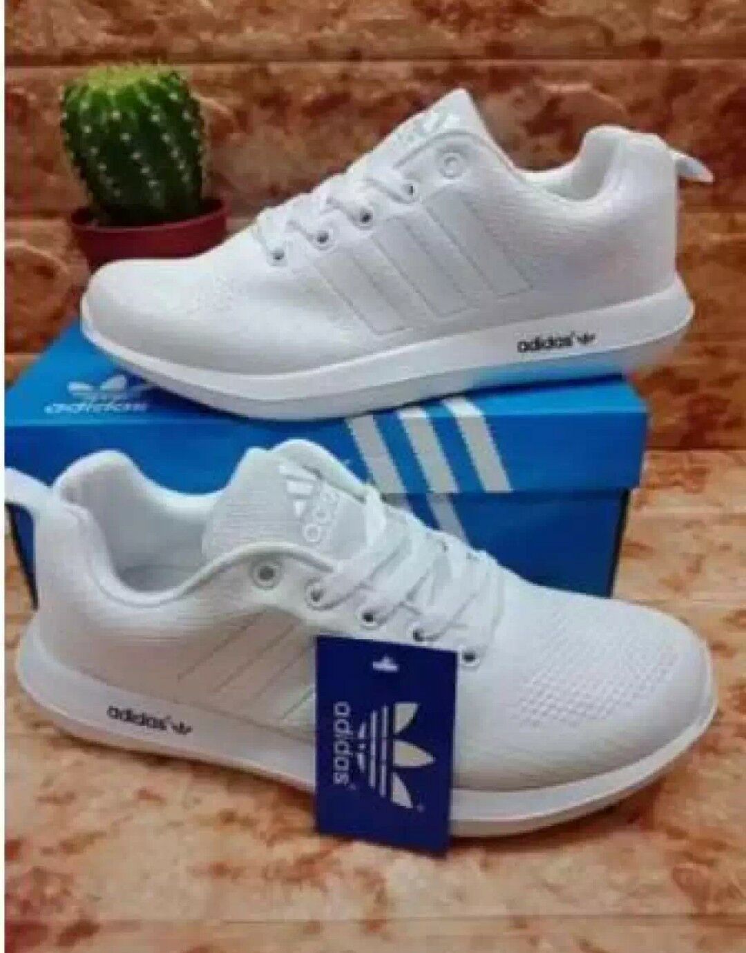 white adidas trainers with green stripes